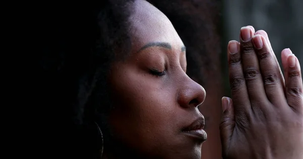 African woman praying to God asking for spiritual guidance