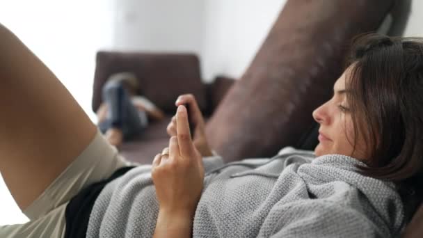 Woman Looking Cellphone Device Home Laying Couch Casually Candid Female — Stock Video