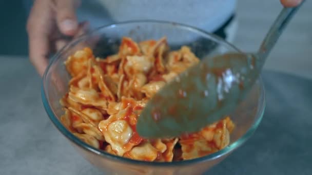 Hand Mixing Ravioli Pasta Red Sauce Bowl Spoon — Stock Video