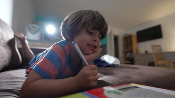 Thoughtful Child Laying Sofa Doing School Homework Activity Pensive Kid — Video