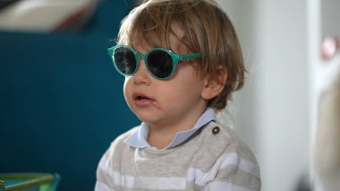 Little toddler baby boy wearing sunglasses