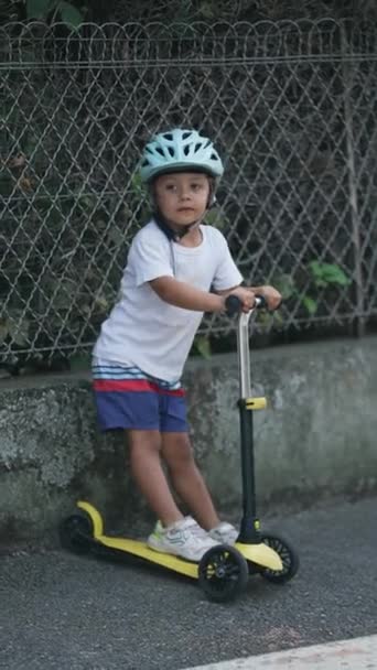 Cute Little Boy Posing Camera Three Wheeled Scooter Protective Helmet — Video Stock