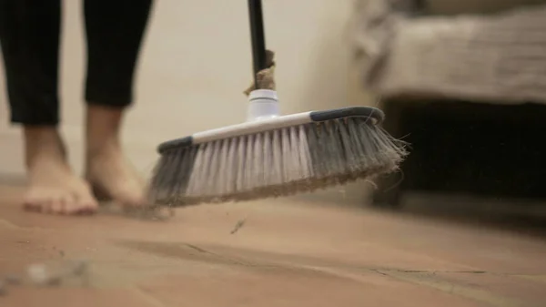 Woman sweeping very drity floor, household cleaning