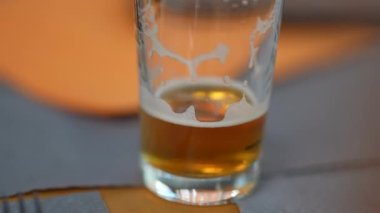 Closeup half empty draft beer at restaurant table