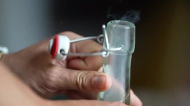 Closeup opening cold glass water bottle soda pop