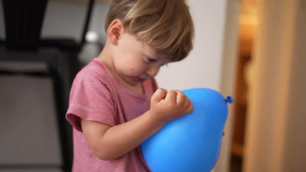 Little Boy Holding Blue Balloon Trying Blow Child Plays Home — Video