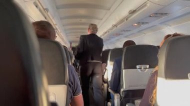 Plane corridor aisle. Passenger seated inside airplane traveling in flight