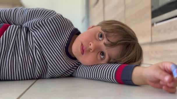 One Bored Little Boy Laying Floor Home Nothing Child Closeup — Video