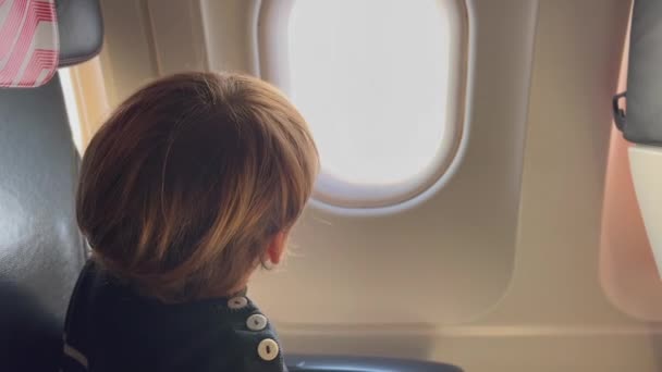 Child Seated Airplane Traveling Passenger Kid Looking Plane Window — Stock video