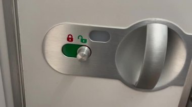 Opening and closing airplane bathroom door inside cabin