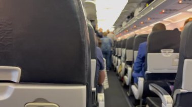 Plane corridor aisle cabin. Passengers boarding airplane. Traveling flight concept