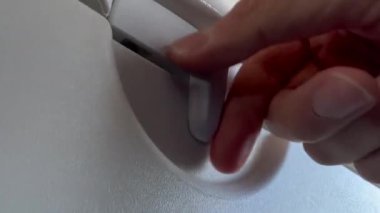 Closeup hand opening and closing plane tray table