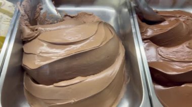 Italian ice cream gelato on display at gelateria with diverse different flavors
