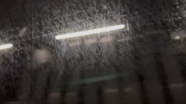 Lights passing by in underground metro subway train with grungy dirty glass surface