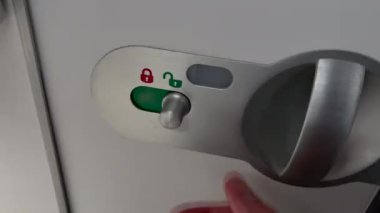 Locking bathroom door symbol inside plane cabin. Occupied airplane cabin lavatory