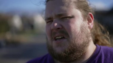 Man with disgust emotion close up face. Portrait of a person with aversion repulsion expression. Judgemental male