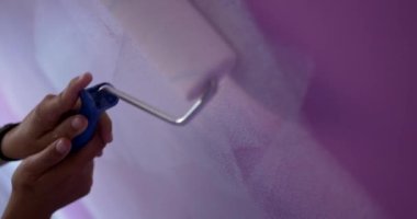 Ev tadilatı yapan bir kadın. Evi beyaz renkte boyamış biri. Boya uygulayan bir ressam