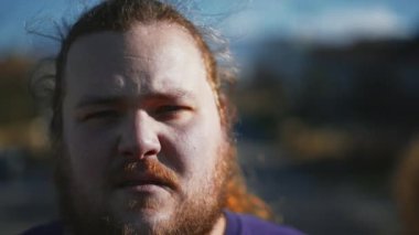 Portrait of an upset casual man close up face looking at camera. One angry male person