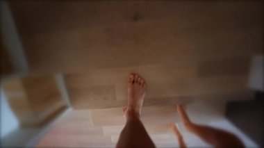 Person feet going up the stairs point of view. POV of legs heading to the second floor of house