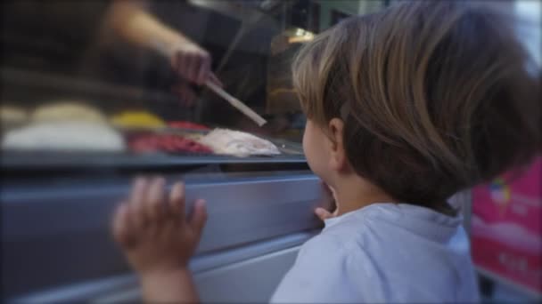 Cute Little Boy Leaning Ice Cream Store Looking Person Scooping — Video