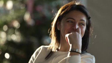 One happy woman laughing and smiling authentic lifestyle. Candid female person real life laugh and smile indoors during sunset golden hour time