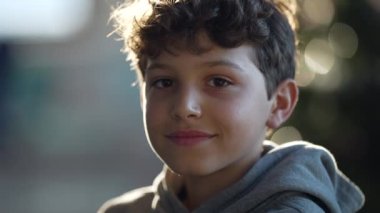 Portrait of a happy young boy close up face looking at camera smiling. One handsome preteen male kid