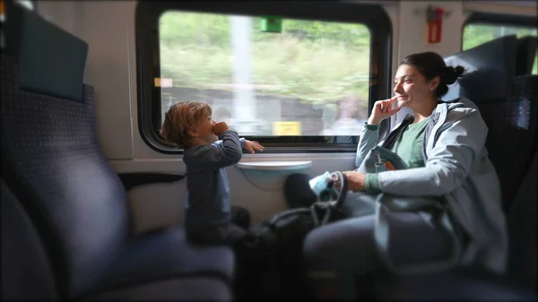 Parent and kid travel by train on commute