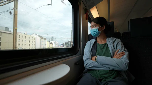 Person wearing covid face mask prevention traveling by train