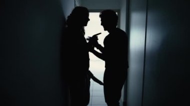 Couple embrace in dark halway during difficult times. Husband hugging parner feeling sorry