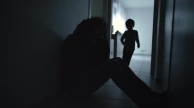 Little boy embracing depressed mother sitting on floor suffering from anxiety. Child consoling parent during crisis