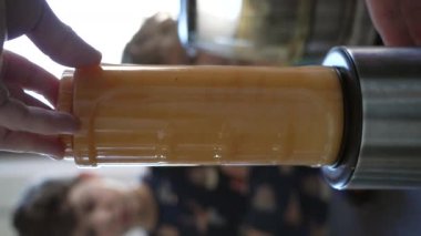 Fruit juicer blending fruits for morning breakfast. Nutritious healthy food. Blender close up in Vertical Video