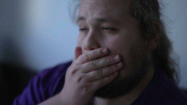 One worried overweight young man close up face feeling anxiety and preoccupation. Desperate person feeling stress