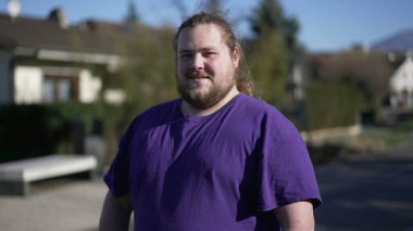 One chubby happy guy looking at camera portrait face close up smiling