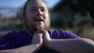 Young man with beard wearing casual clothes feeling very happy and excited doing winner gesture with arms raised. Person smiling and screaming for success. Celebration