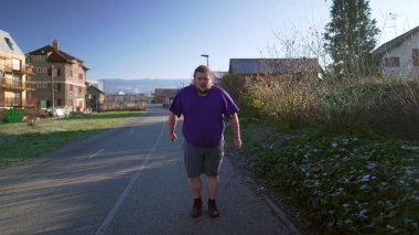 One overweight man starts to run outside getting back to into shape. Male big caucasian person running outdoors exercising body. Motivational discipline concept