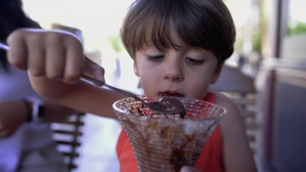 Kid Eating Chocolate Ice Cream Dessert Spoon Portrait Face Closeup — Stockvideo