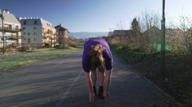One young overweight man stretching legs before run. Back to fitness concept of a male plus size caucasian person returning to sport stretches body