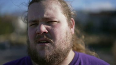Man with disgust emotion close up face. Portrait of a person with aversion repulsion expression. Judgemental male