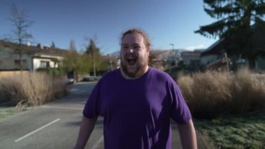 One ecstatic young fat man feeling joy. Happy person celebrating success. Portrait face closeup in tracking shot of happiness concept