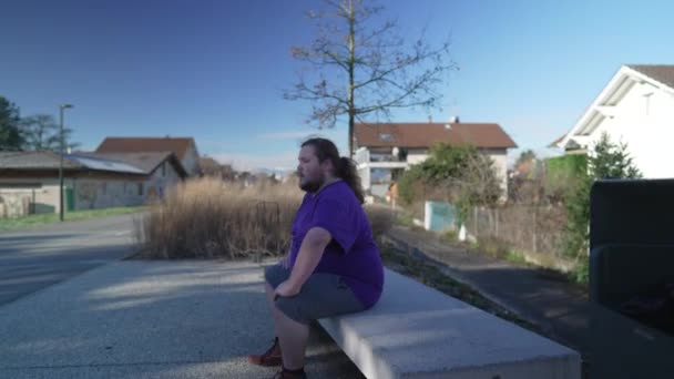 One Young Overweight Man Sitting Park Bench Contemplative Person Relaxing — Stockvideo