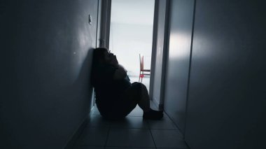 One man depressed person feeling despair in corridor suffering from mental illness alone at home. Man feeling loneliness and depression