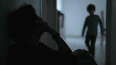 Son hugging father during crisis. Child consoling dad in difficult times. Depressed father suffering from financial problems. Kid hugging dad