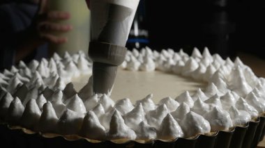 Pastry pag adding cream on top of cake decoration. Cooking cake