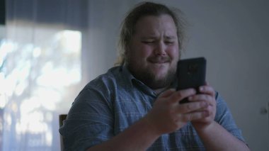 One excited fat man celebrates success in front of computer. close up male person face feeling happy. WOW winner emotion