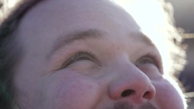 Spiritual young man closeup eyes looking at sky smiling feeling GRATITUDE. Hope and Faith concept