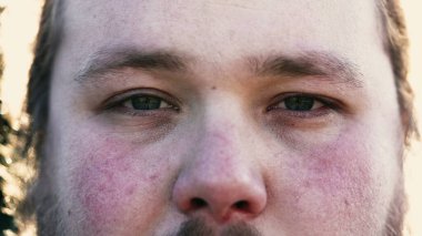 Young man macro eyes close up looking at camera