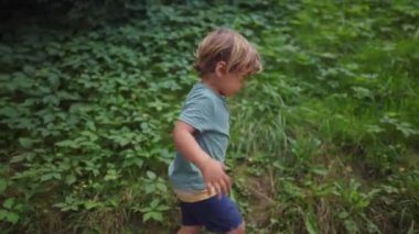 Child hiking outdoors. One active small boy exercising in nature