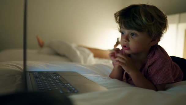 Child Watching Entertainment Media Laptop Screen Laying Bed Night Hypnotized — Stockvideo
