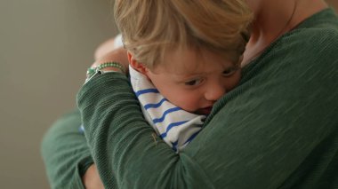 Motherhood love and affection. Parent hugging and embrace little boy son. Mom caring for child. Parenthood lifestyle