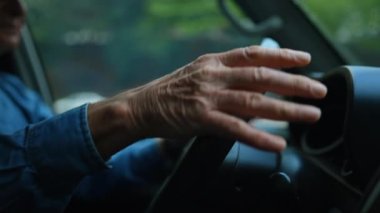 Close up hands holding steering driving in city. Driver signaling turn. person drives car.mov